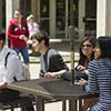 Group of students at a table outside Group of students at a table outside