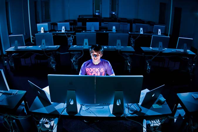 Photo of guy sitting in a computer lab