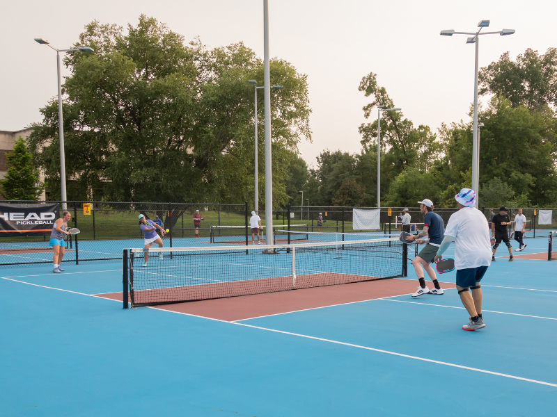 Pickleball Resized Several individuals playing pickleball.